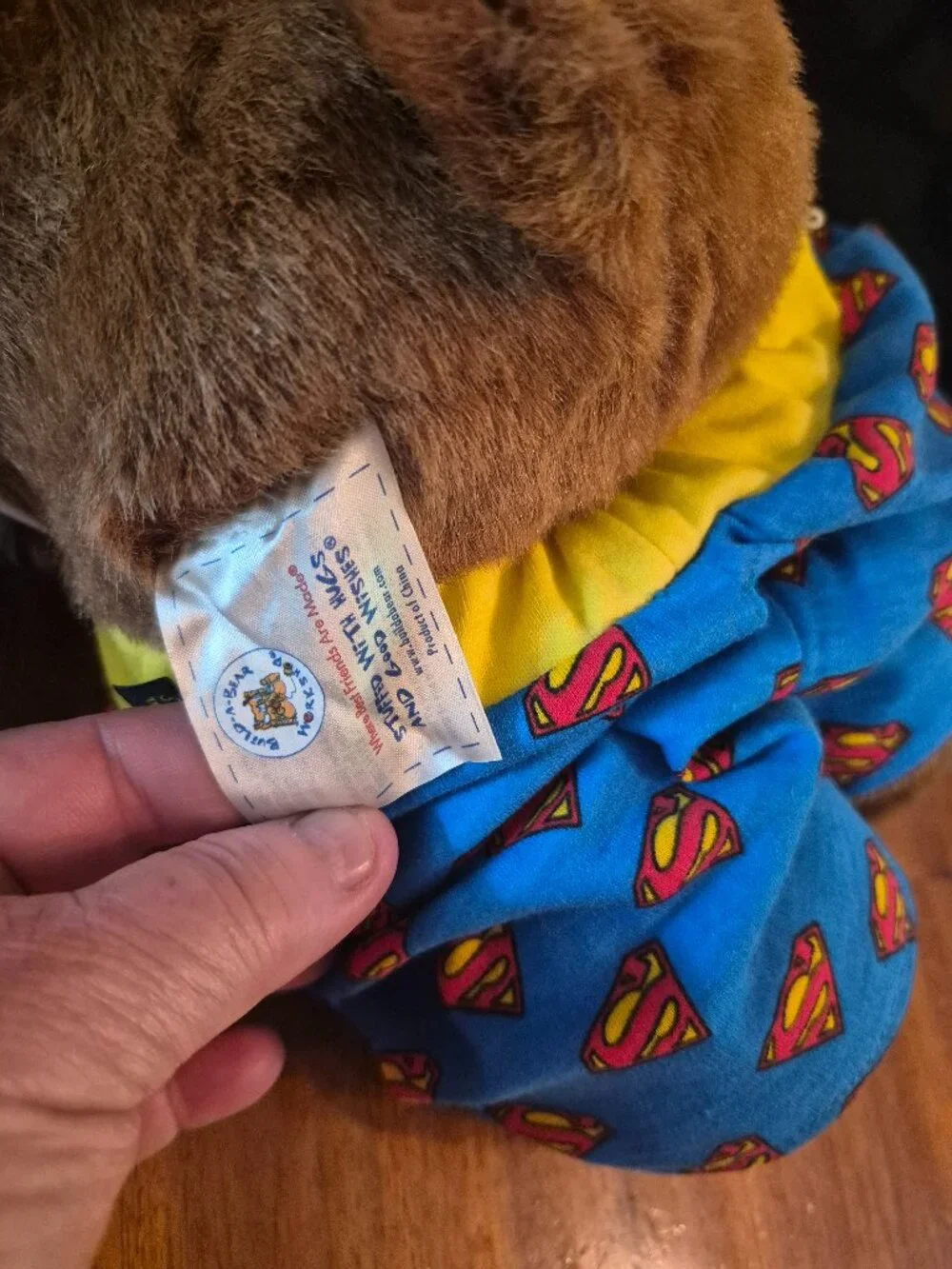 Build-A-Bear Workshop teddy bear wears a casual Superman-themed outfit with bows